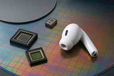 Disassembled earbud showing internal chips and labeled substrates